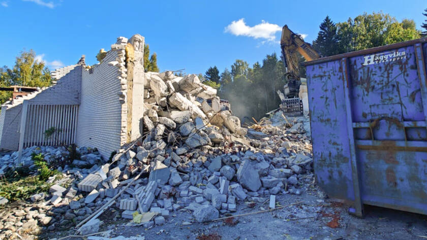 Kaivuri purkaa rakennusta
